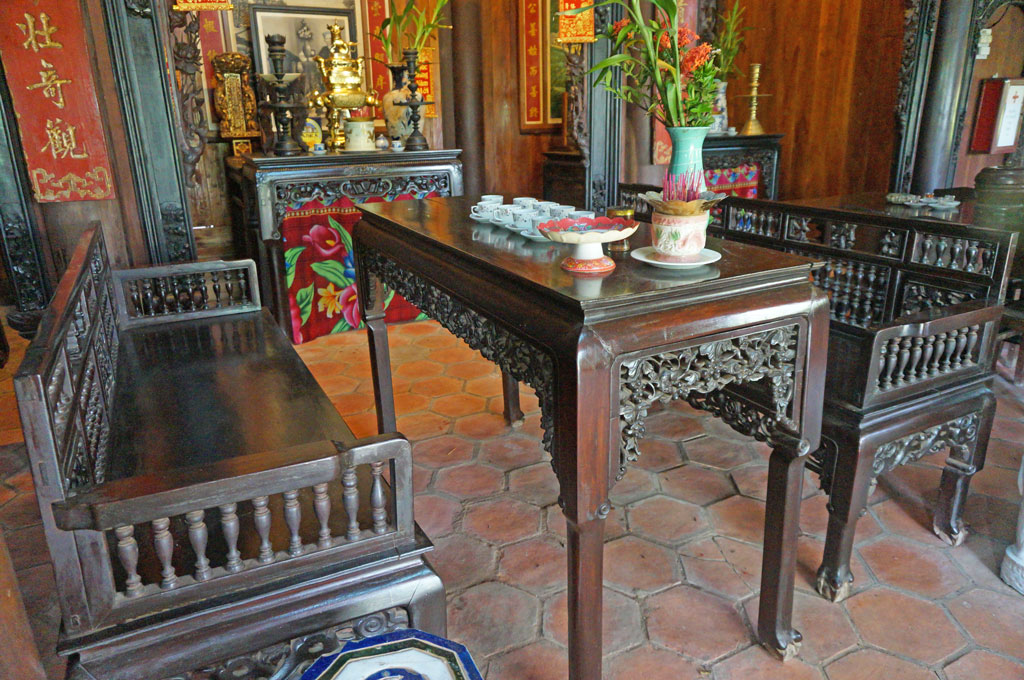 An antique hand carved wooden settee set in the living room