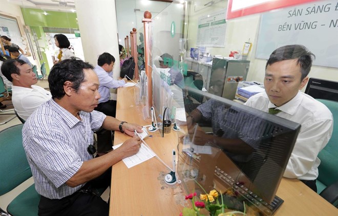 A trading counter at the Joint Stock Commercial Bank for Foreign Trade of Vietnam (Vietcombank) (Photo: VNA)