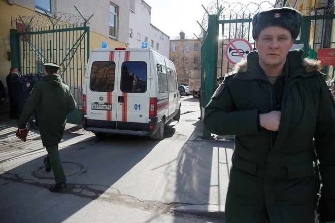 Soldiers guard an entrance as an ambulance drives into the Alexander Mozhaysky Military Space Academy in St. Petersburg, Russia. (Photo: AP)