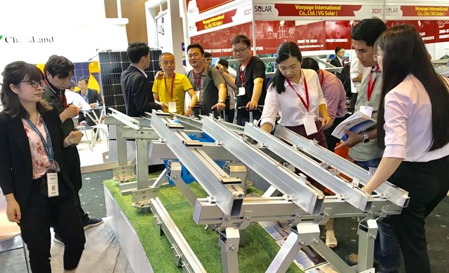 Visitors visit a booth on Solar Show 2019 in HCM City. (Photo: VNA)