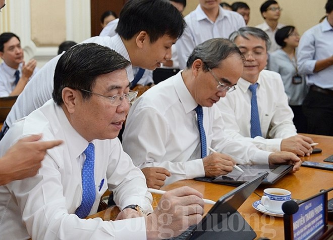 Leaders of the city try the e-Cabinet paperless meeting system (Photo: congthuong.vn)