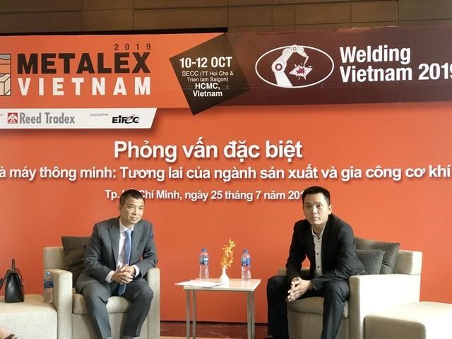 Vu Trong Tai (L), general manager of Reed Tradex Vietnam, and Huynh Phong Phu, local business manager, robotics and discrete automation, ABB Vietnam, in an interview with the local media in HCM City on July 25. (Photo: VNA)