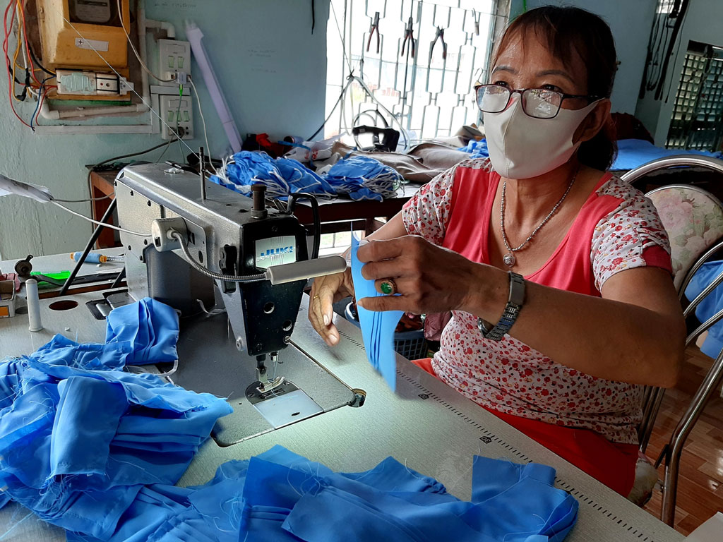 Members of Women Union sew face masks to present to the poor