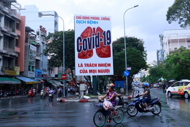 Motorbikes drive past a billboard warning against the coronavirus disease after the government eased nationwide lockdown during the outbreak in Ho Chi Minh City, Vietnam (Photo: Reuters) 