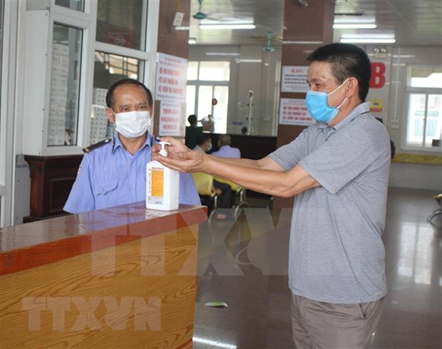 Hand disinfection is compulsory at medical facilities. (Photo: VNA)