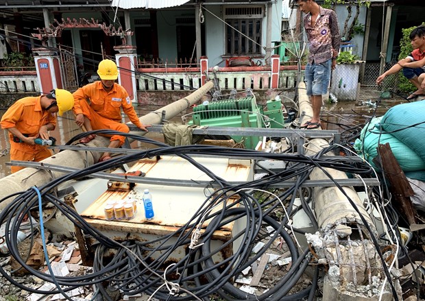 Staff of the Electricity of Vietnam helped people fix damaged electricity facility (Photo: VNA)