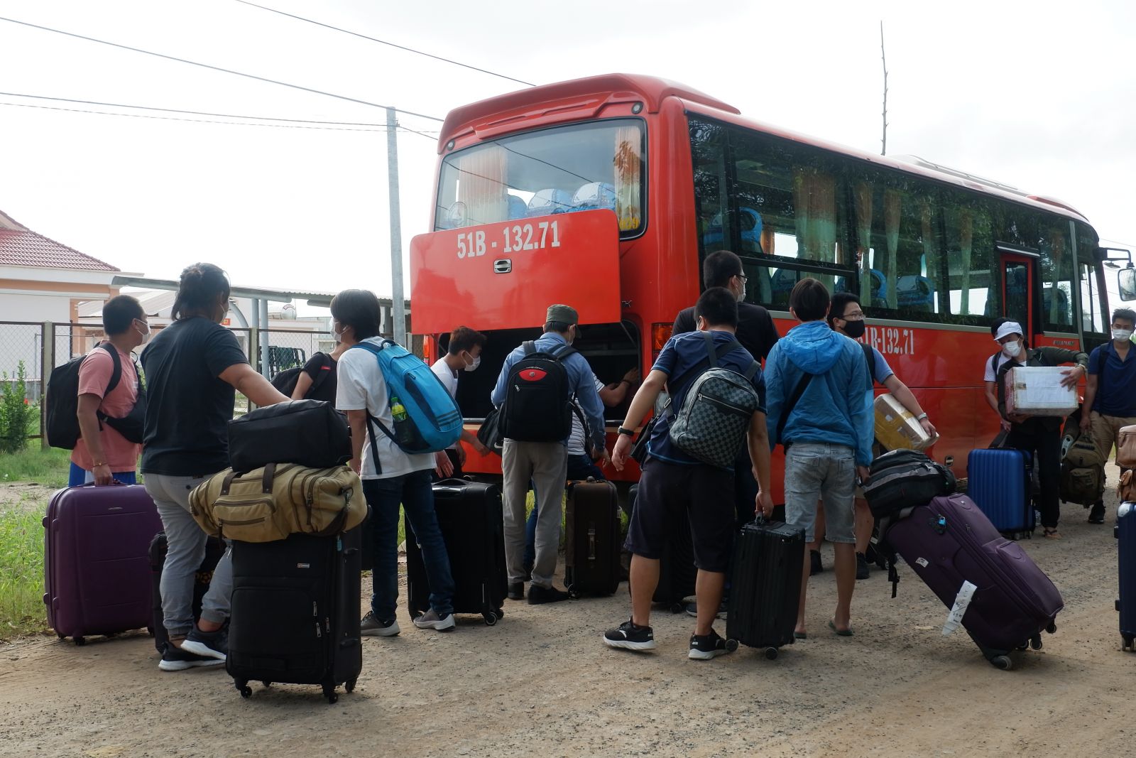 Residents collect luggage to return home after completing the 14-day quarantine