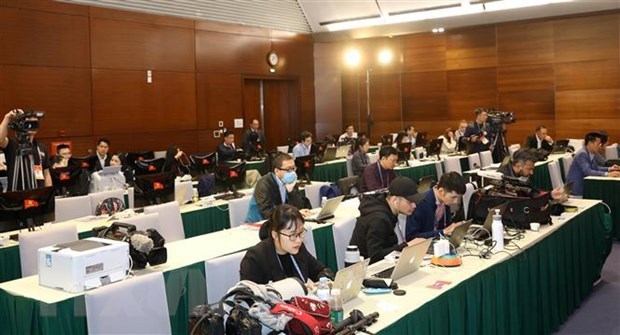 Reporters of foreign news agencies work at 13th National Party Congress's press centre (Photo: VNA)