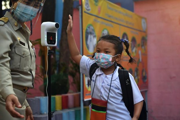 A student undergoes a temperature check as schools reopen due to the easing of restrictions after a temporary closure to combat the spread of the Covid-19 coronavirus in Bangkok. (Photo: AFP)