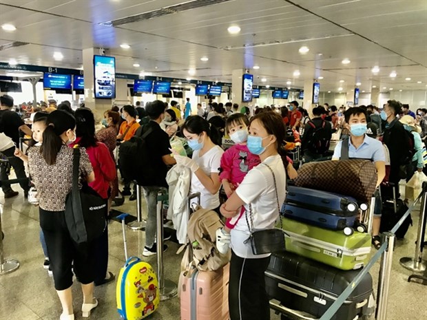 Passengers wait for check-in at the domestic terminal at Tan Son Nhat international airport in HCM City (Photo: VNA)