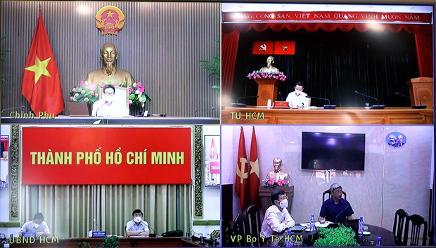 The teleconference between Deputy PM Vu Duc Dam and officials of HCM City and the Health Ministry on July 10 (Photo: VNA)