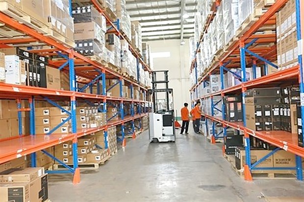 Digiworld's employees checking goods in its warehouse. (Photo: VNA)