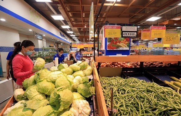 Customers choose vegetables at a supermarket in HCM City during an earlier lockdown. (Photo: VNA)