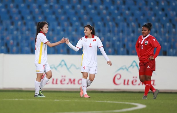 Vietnamese players (in white) celebrate their goal at the game (Photo: VNA)