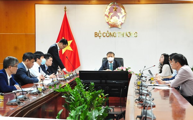 Deputy Minister of Industry and Trade Do Thang Hai (centre) and other officials at the teleconference on October 14 (Photo: VNA)