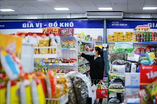 A consumer chooses products at a supermarket. (Photo: VNA)