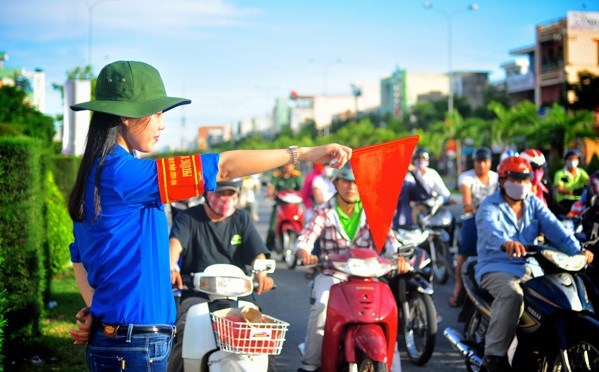 A volunteer helps regulate road traffic. (Photo: doanthanhnien.vn)